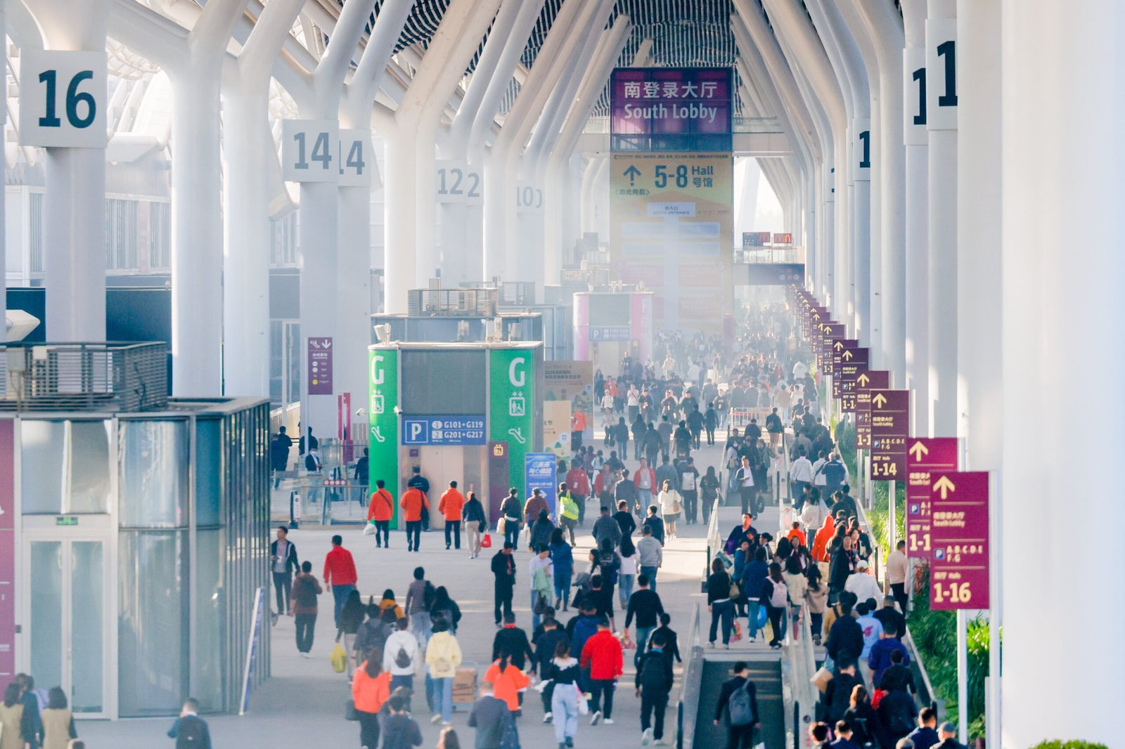 Visitors walking through a large exhibition hall in China.